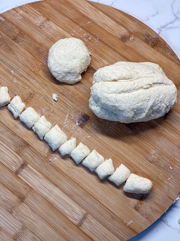 gnocchi dough rolled into a ball then rolled into a log to be cut into gnocchi