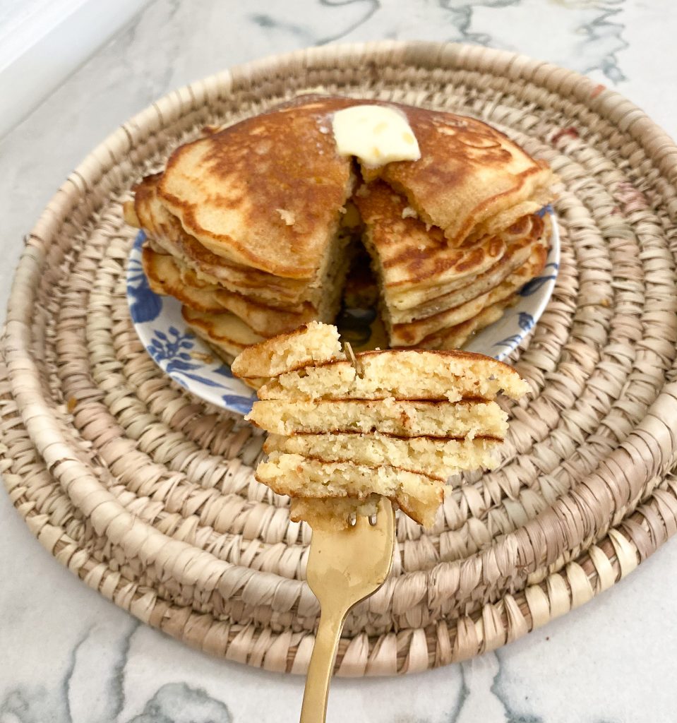 close up shot of pancakes on a gold fork
