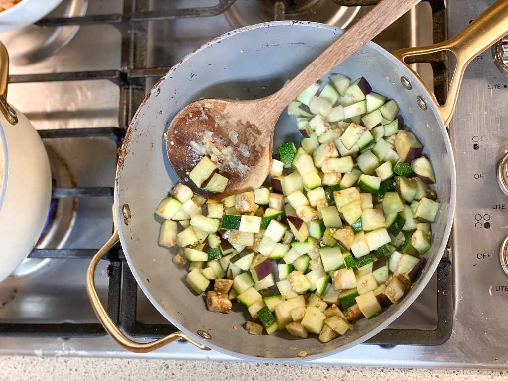 zucchini and eggplant cooking on a stove w