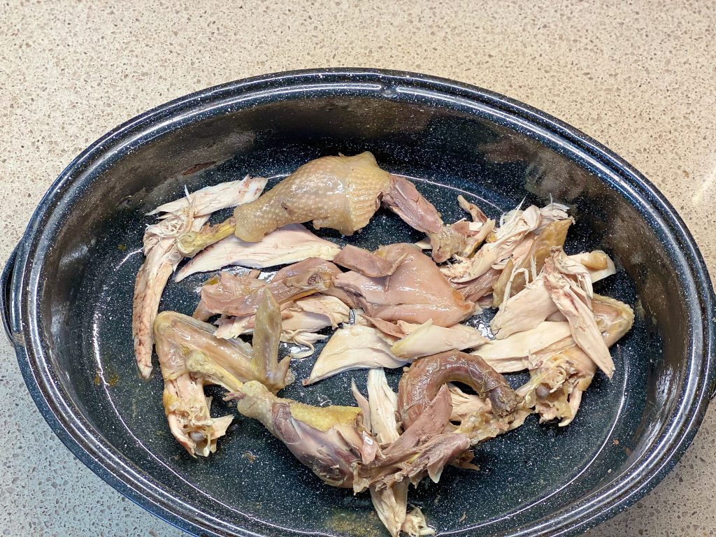 shredded chicken in a black pot