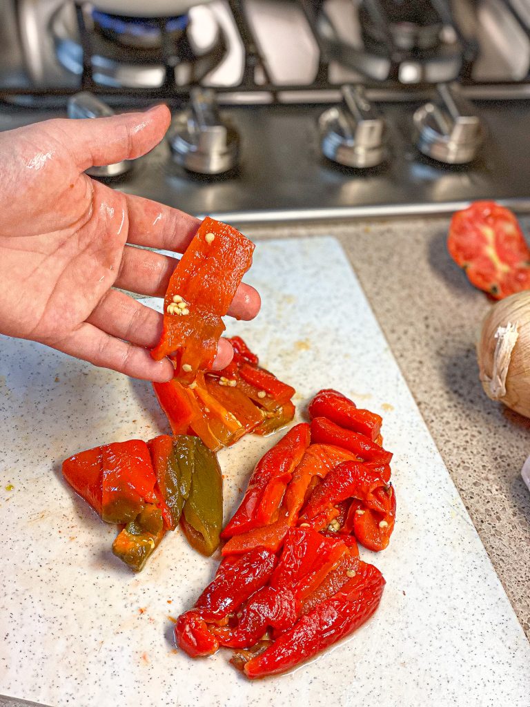 hand holding chopped roasted bell peppers