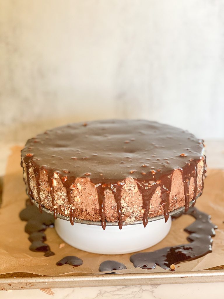 chocolate ganache dripping on the sides of a Ferrero rocher mousse cake