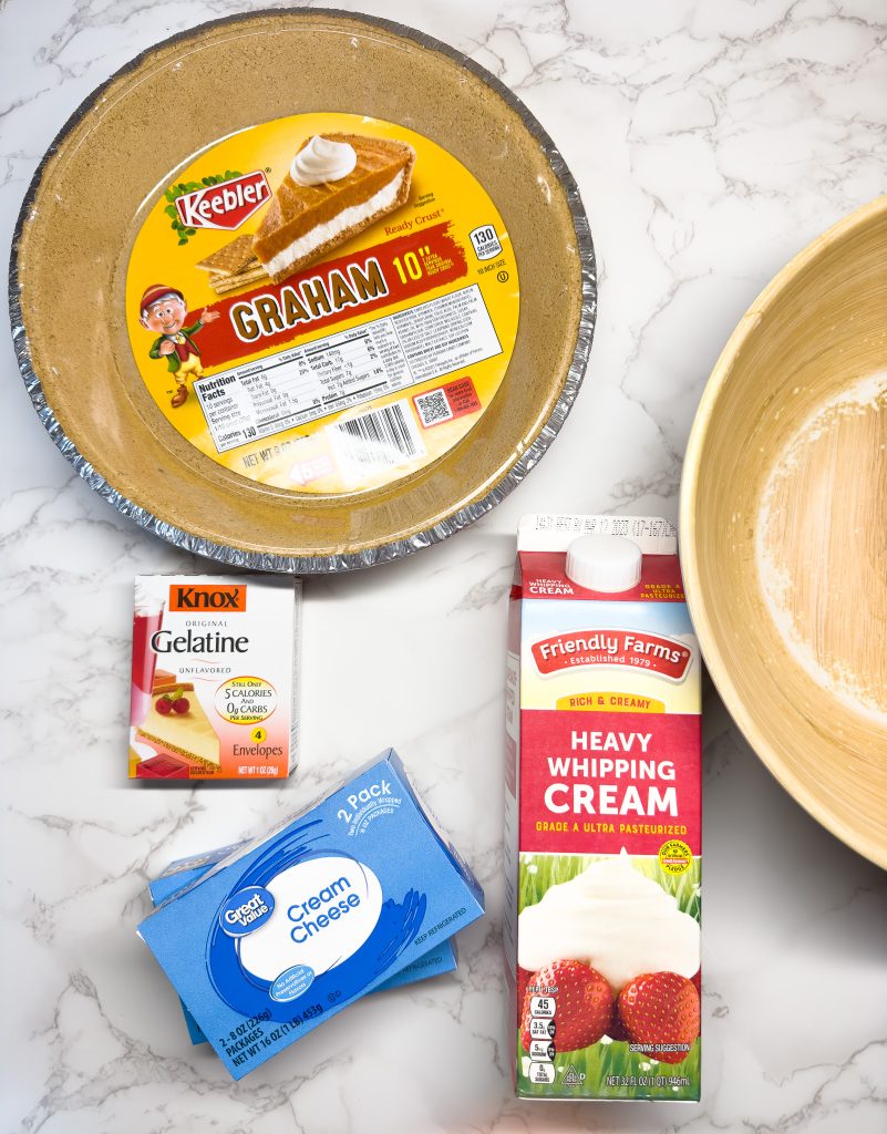 ingredients to make no bake cheesecake laid out on a countertop. 