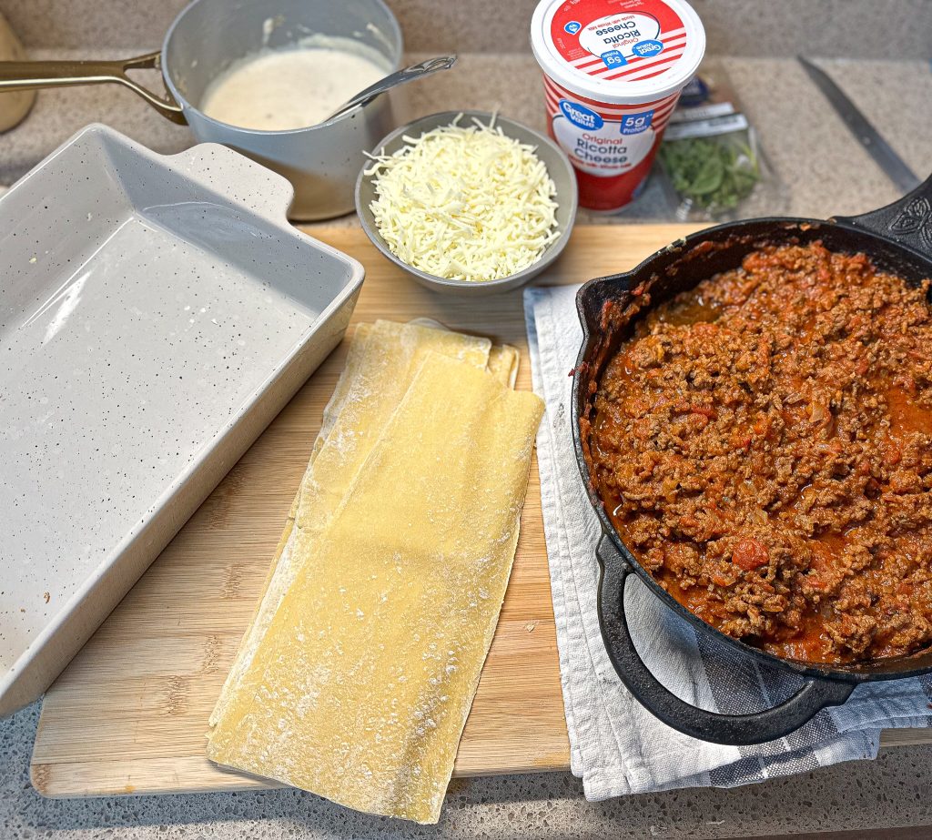 ingredients laid out on a countertop to assemble lasagna with bechamel sauce