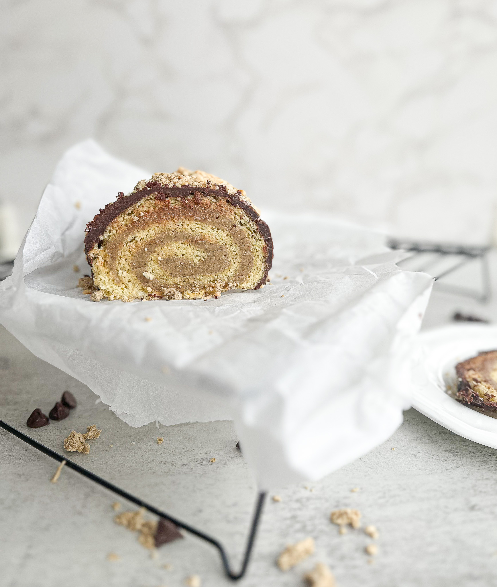 Halva (tahini) roulade glazed with chocolate and hazelnuts
