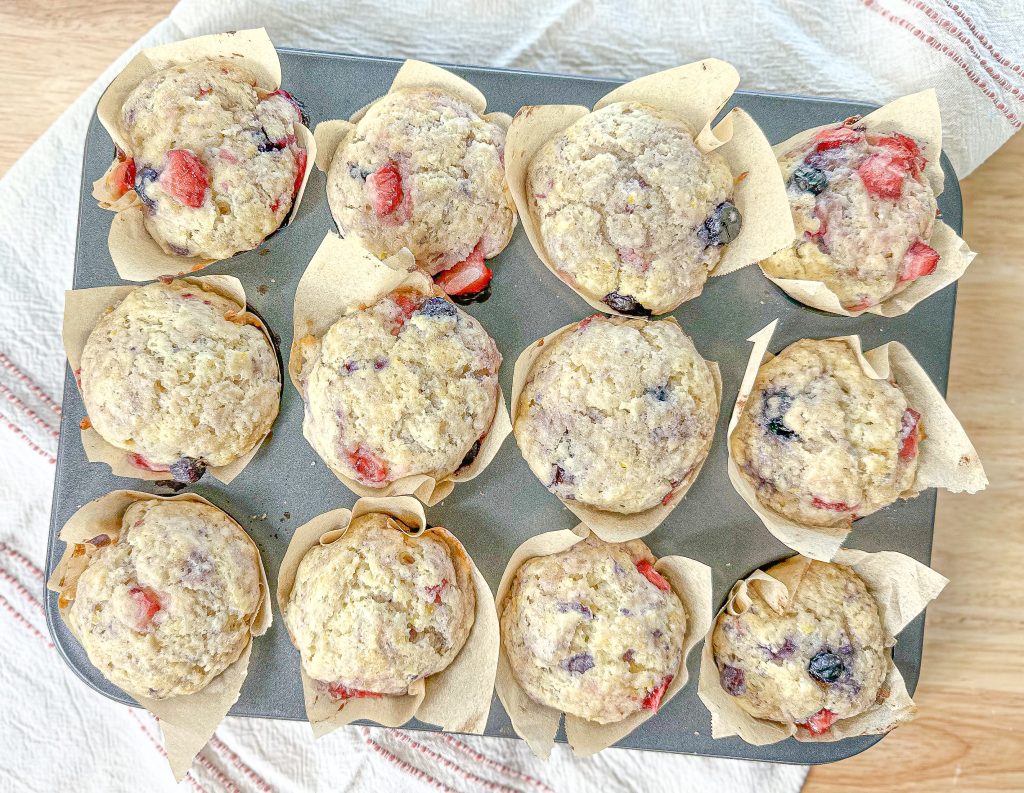 easy lemon ricotta muffins ( with berries) baked in a muffin tin