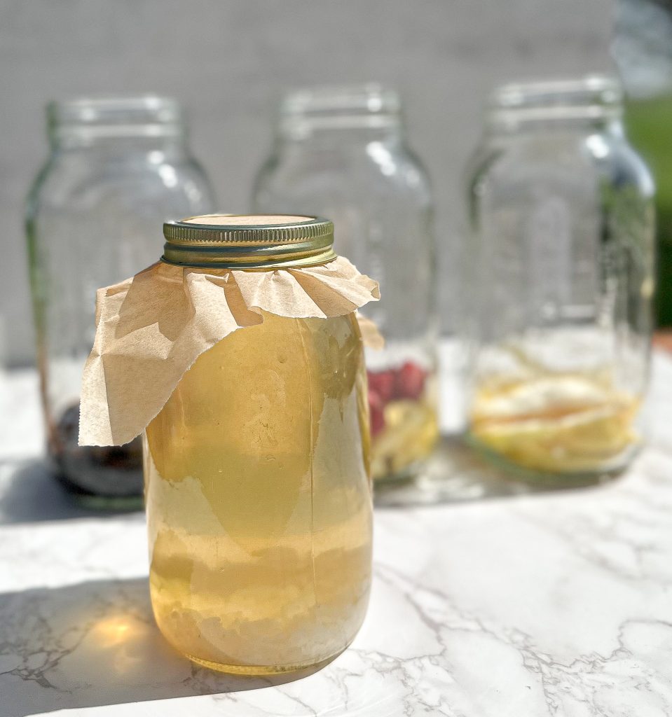 water kefir grains fermenting in a glass jar in sugar water