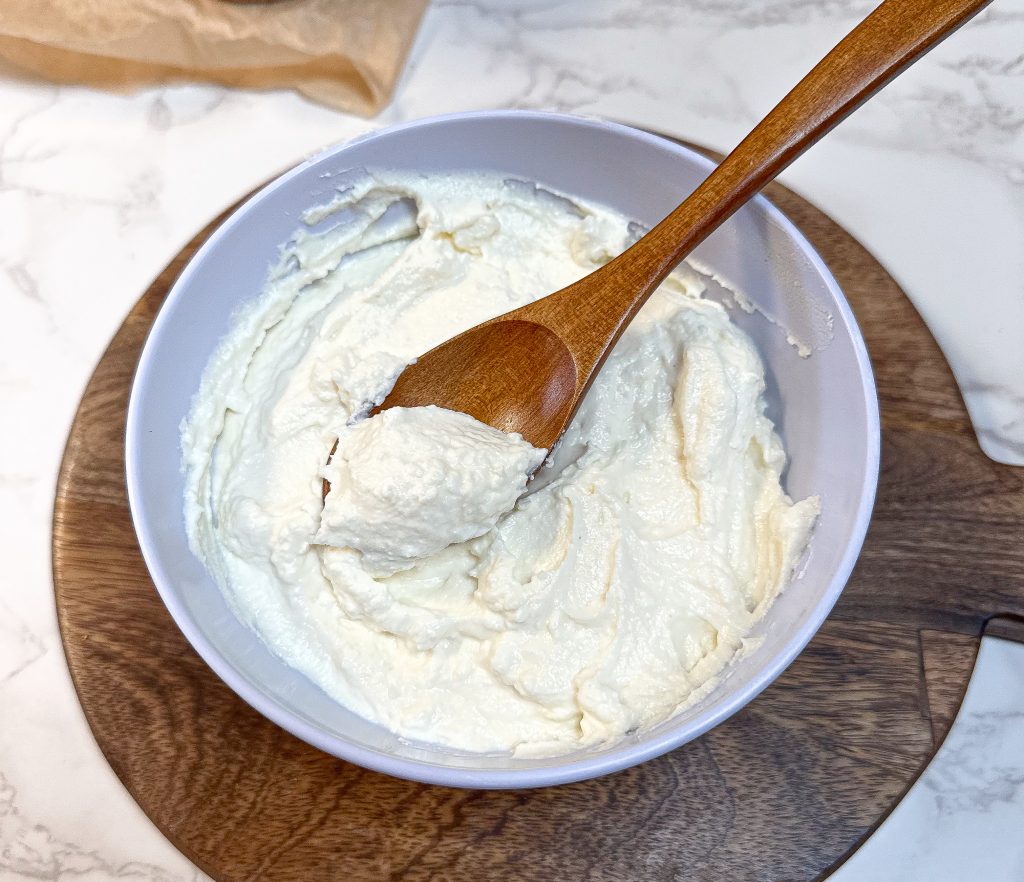 raw milk Greek yogurt made in the instant pot in a white bowl with a wooden spoon