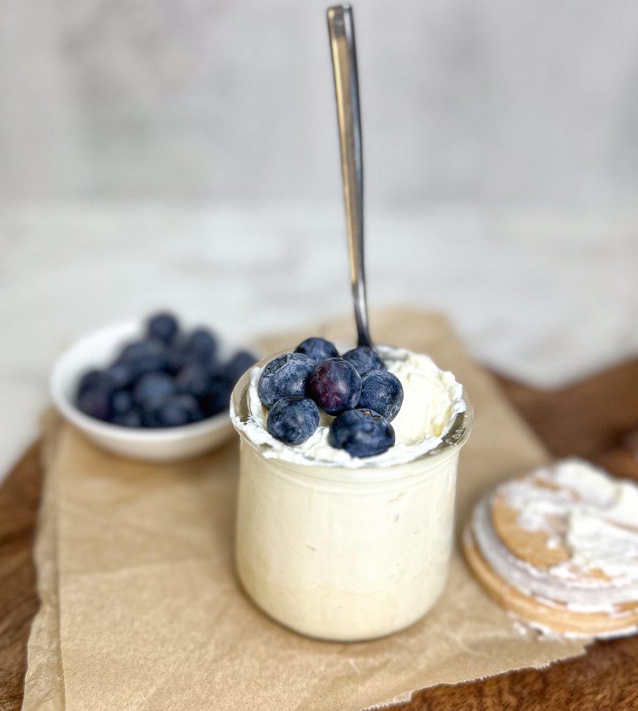 raw milk Greek yogurt made in the instant pot in a glass yogurt jar with fresh blue berries on top