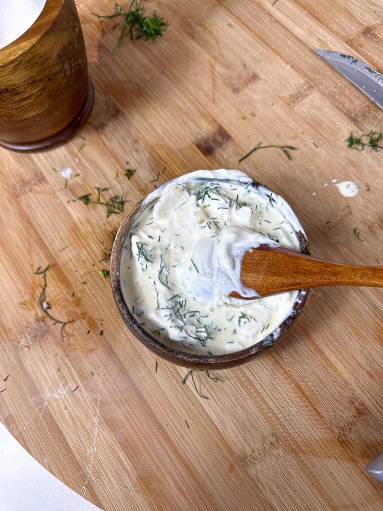 The best sauce to serve with zucchini fritters in a wooden bowl with a wooden spoon