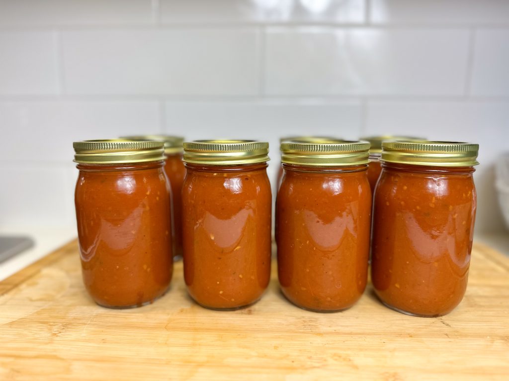 jars lined up in a row with canned easy homemade marinara sauce recipe