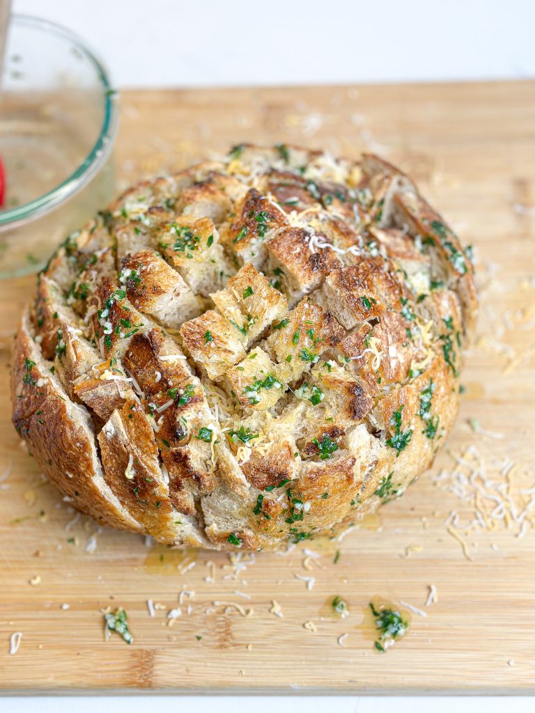sourdough bread stuffed with cheese, garlic, butter, and fresh herbs