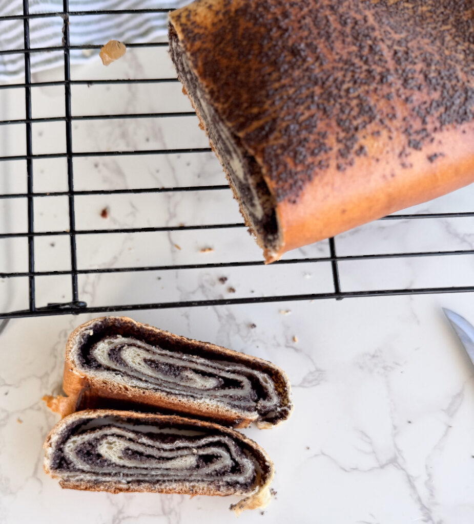 Sliced poppy seed vertuta showing tight, even sourdough swirls with a rich poppy seed filling.