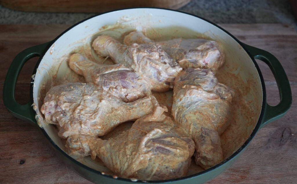 Marinating: Chicken drumsticks coated in a creamy mayonnaise, garlic, and seasoning marinade before being refrigerated.